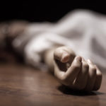 Dead woman’s body with focus on hand