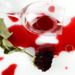 Broken glass, faded rose and a ring after an argument