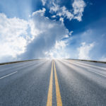 asphalt highway under the blue sky