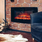 Cozy room with fireplace, fur skin and pile of woods.