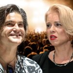 Festival crowd in front of the stage at night.